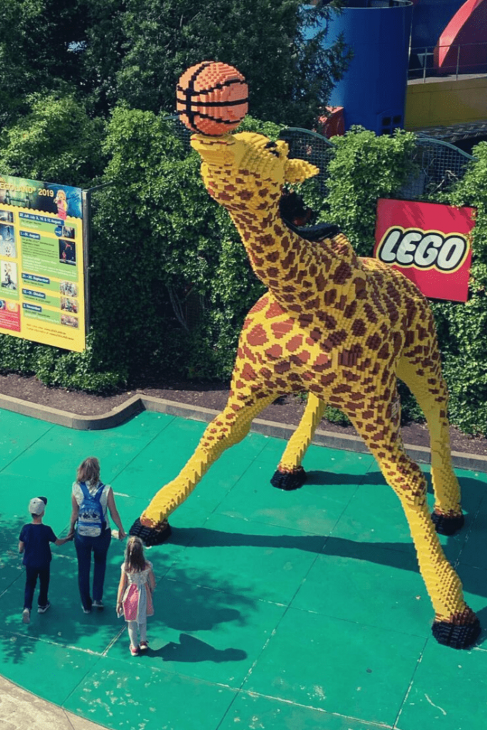 Giant giraffe playing basketball all made of Lego; one of the many Lego creations to admire at Legoland Deutschland. Princesses, dinosaurs and Lego: Day trips in and from Munich.