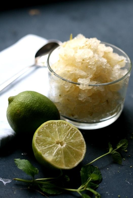 Refreshingly simple Caipirinha sorbet, in a glass with fresh limes