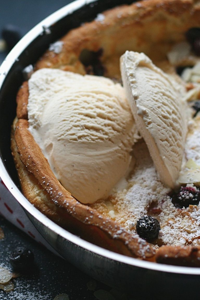 Bavarian blueberry pancakes with powdered sugar, vanilla ice cream and toasted almond flakes