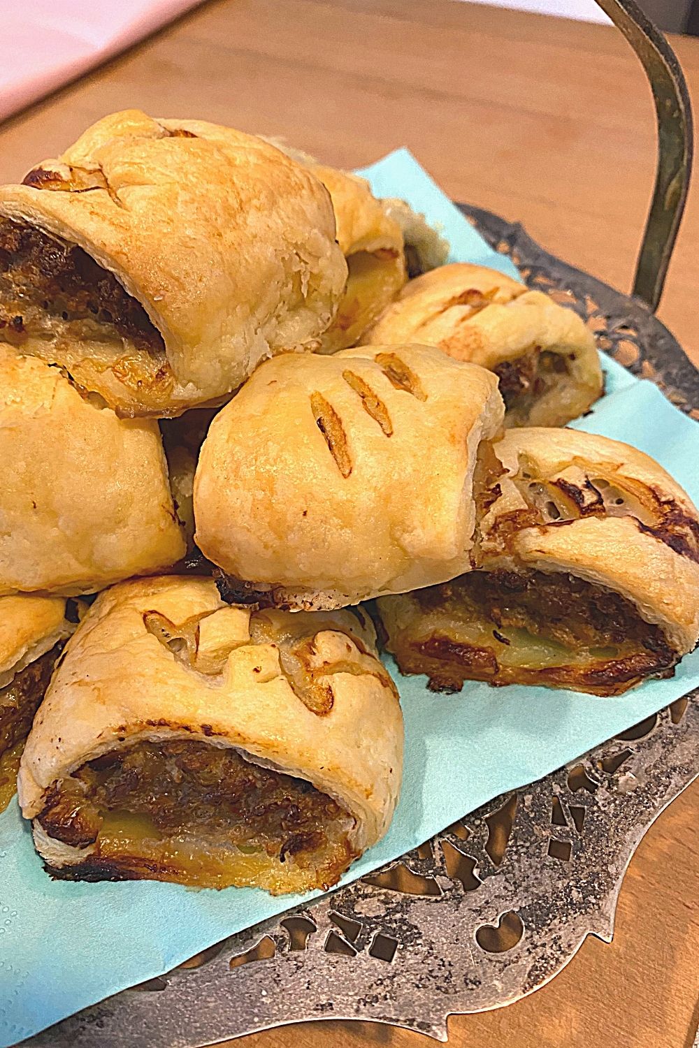Antique silver tray with pork and apple sausage rolls