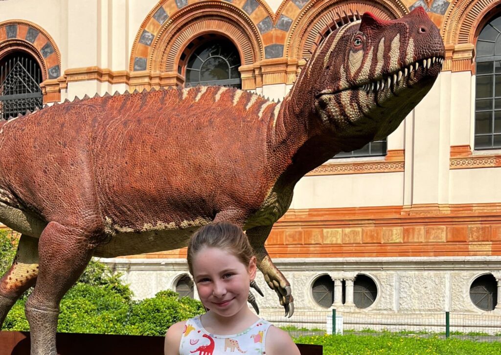 Miss M with a life-sized Saltriovenator in front of the Natural History Museum. Visit the prehistoric beasts for free!