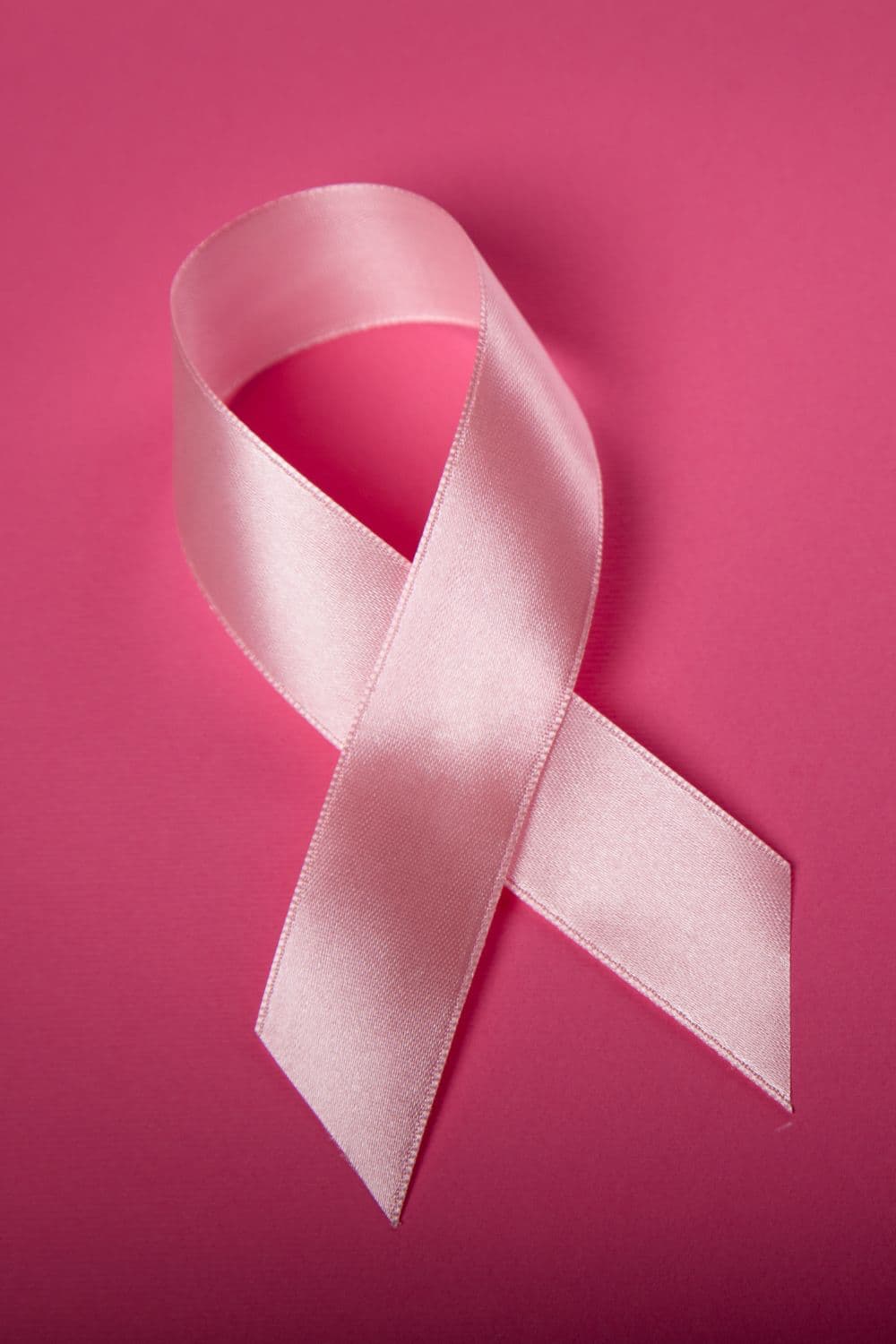 Pink ribbon - the symbol of breast cancer awareness - on a pink background. Hero image to signify my current (health) war.